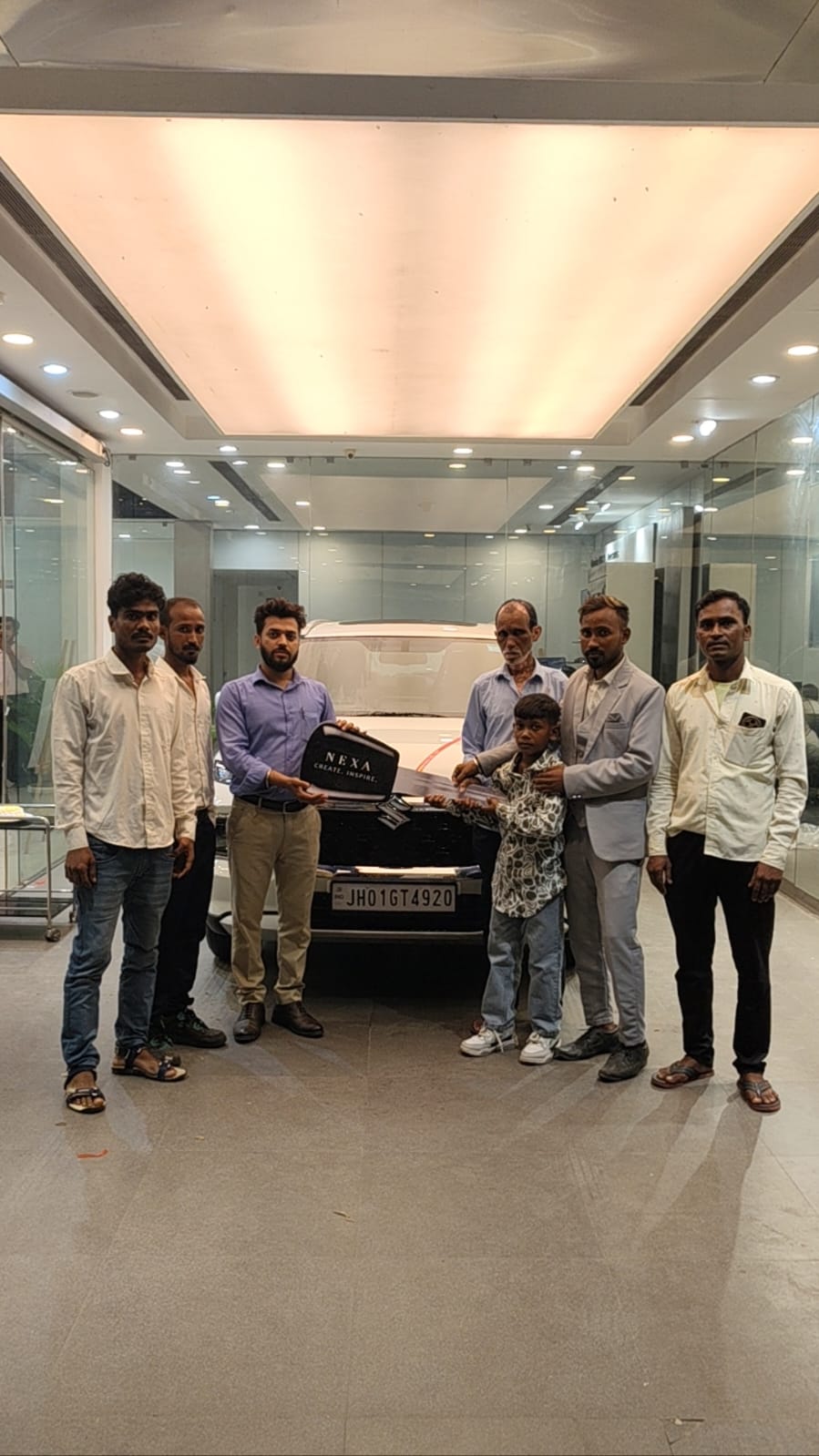 Happy customer smiling with new Maruti Suzuki car