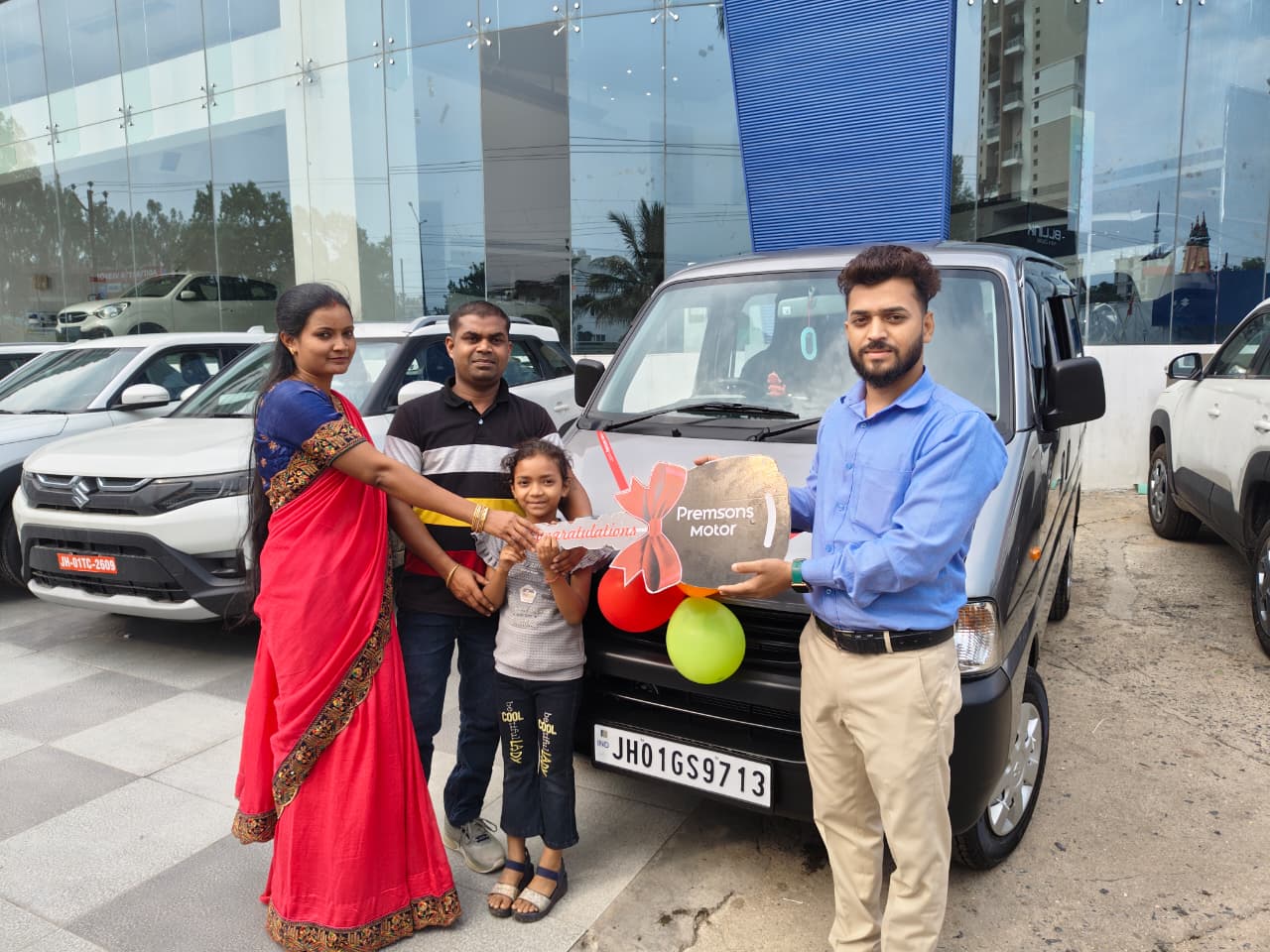 Smiling customer driving new Maruti Suzuki