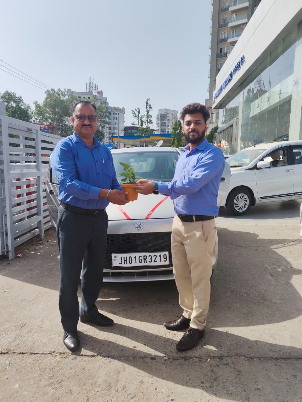 Car delivery ceremony with happy customers